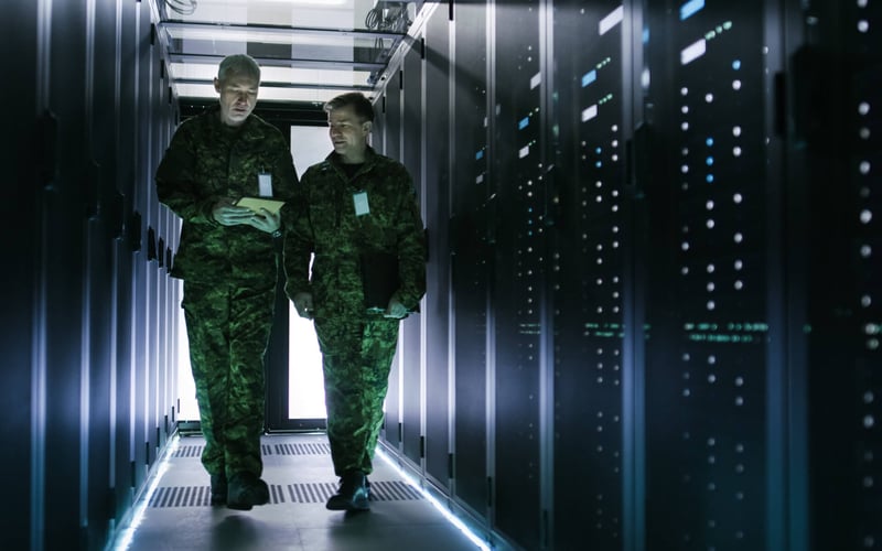 Image of two military personnel walking through a data center
